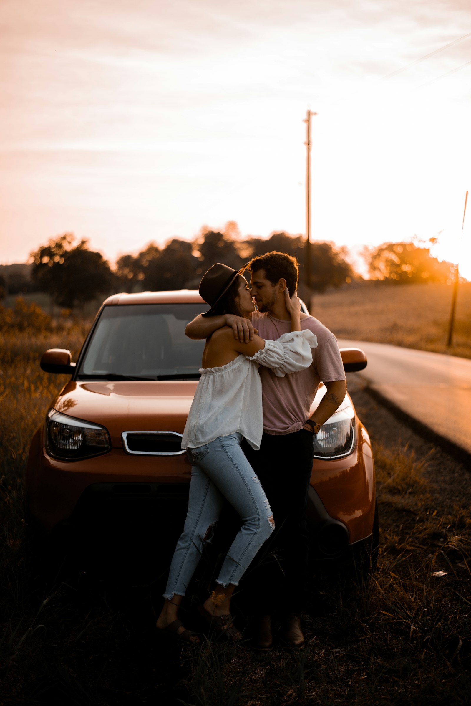 A couple sharing a quiet moment on a country road